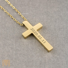 Gold engraved cross pendant close-up