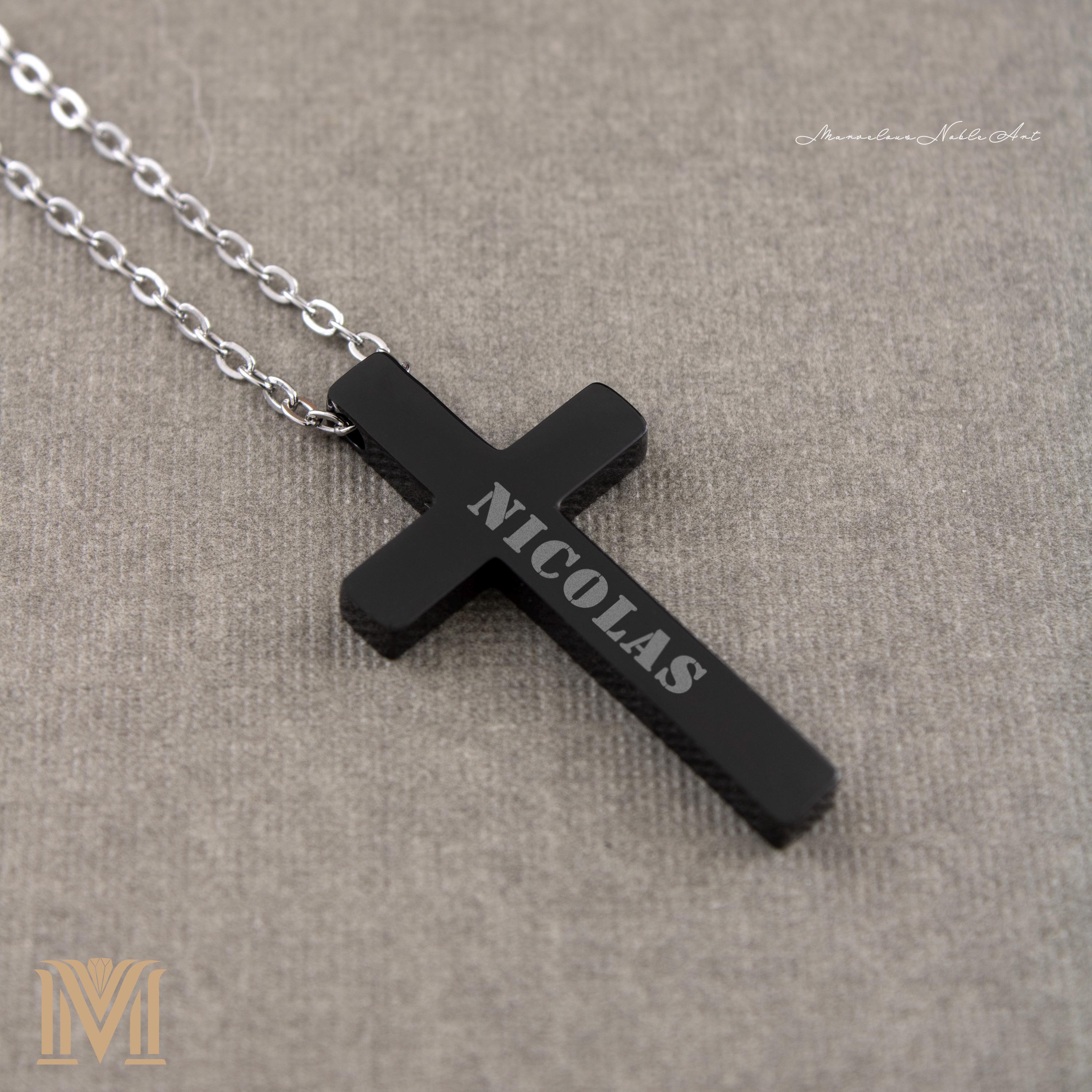 Black engraved cross pendant close-up