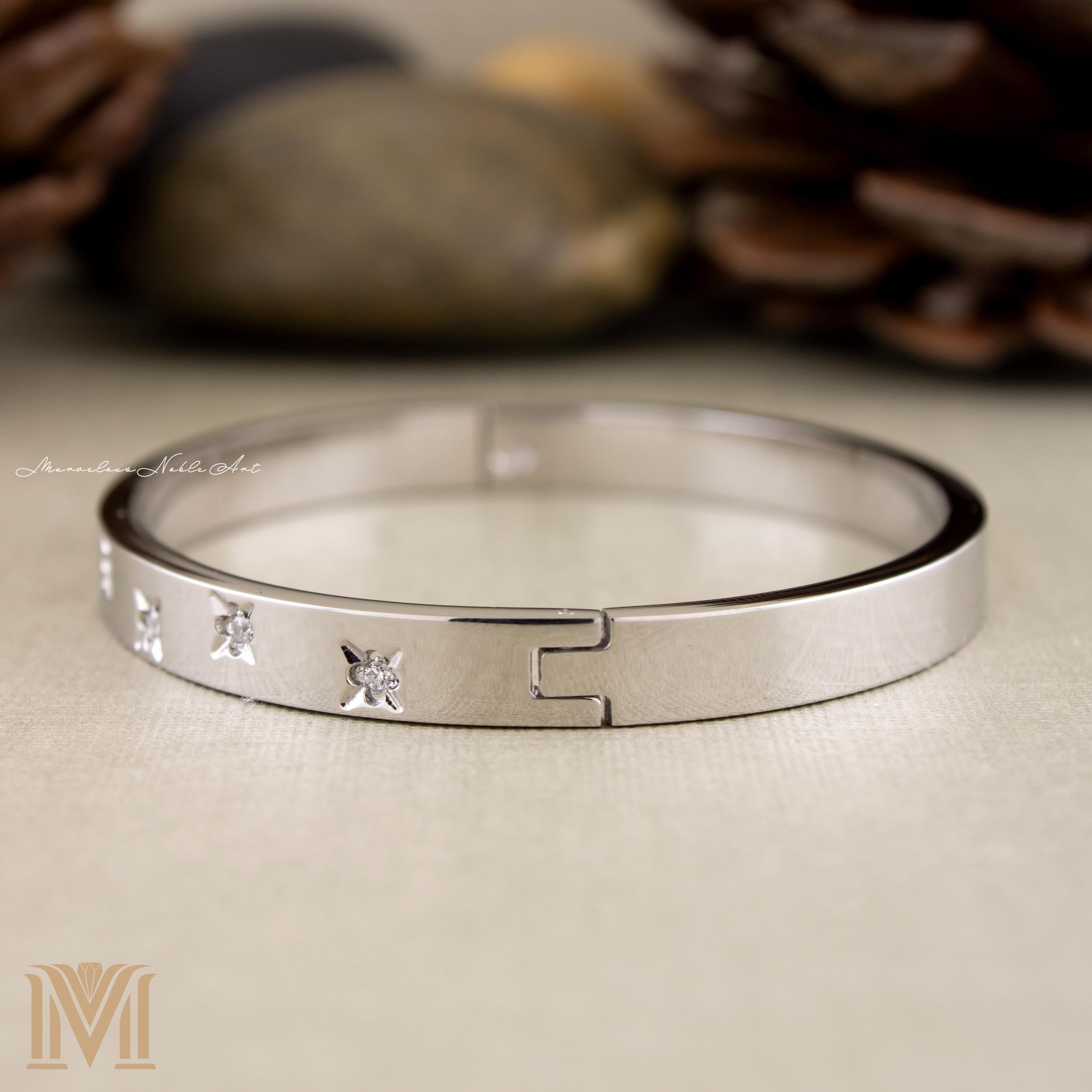 Silver bangle side view with star accents