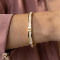 Model wearing personalized gold bracelet