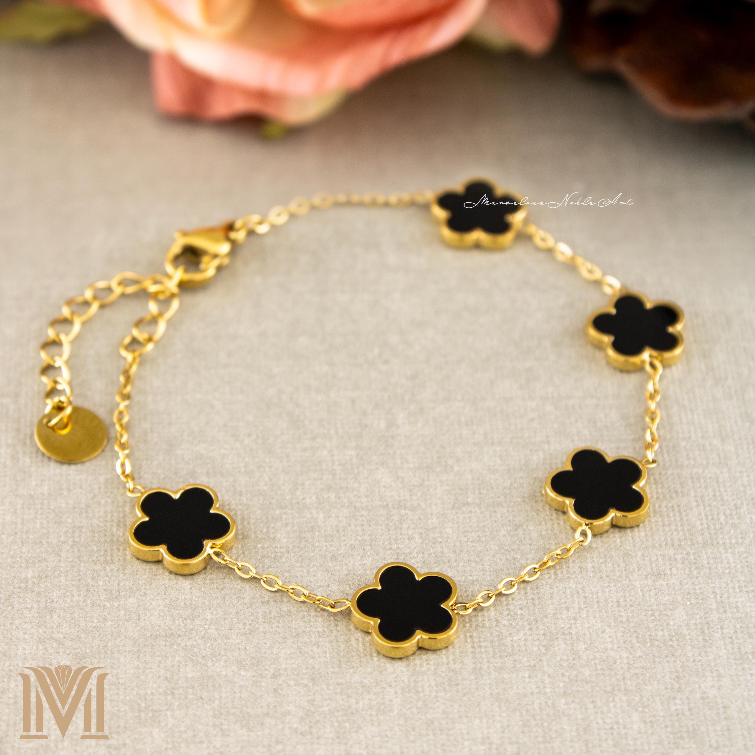 Five black clover charms on gold plated bracelet