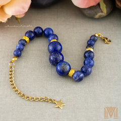 Gold clasp extender and star charm detail