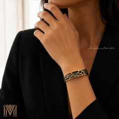Woman wearing gold and black geometric cuff