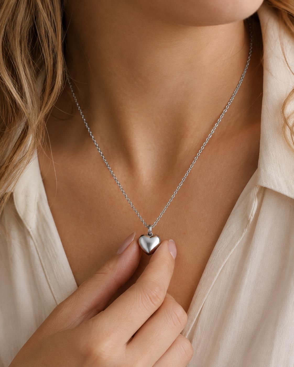 Woman wearing silver heart memorial urn necklace