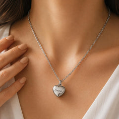 Woman holding heart ashes keepsake necklace