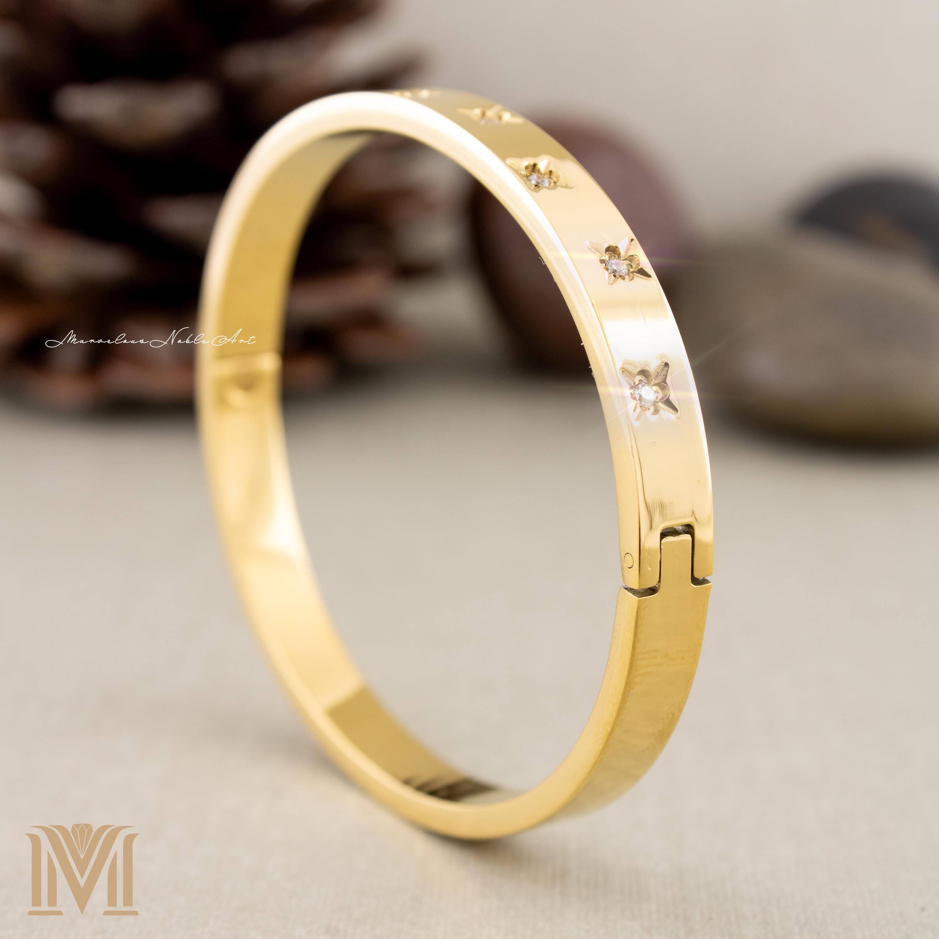 Gold bangle with crystal star design