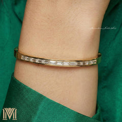 Personalized women's gold bangle worn on wrist