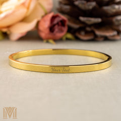 Gold bangle with custom engraving example