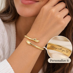 Personalized gold hug cuff worn on wrist with engraving detail