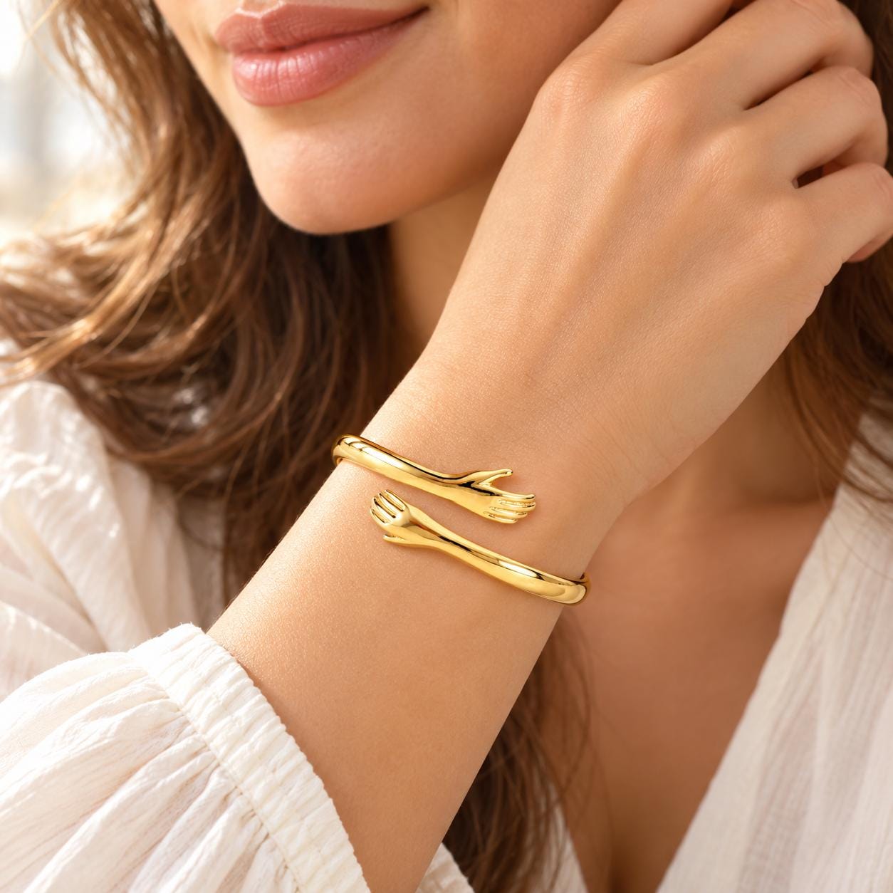 Woman wearing gold hug cuff in natural light